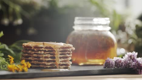 Close-up-of-honey-falling-on-pancakes