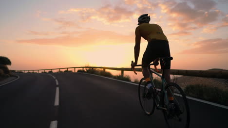Slow-motion-captures-the-athlete-cycling-on-a-mountain-serpentine,-savoring-the-island's-view,-symbolizing-a-commitment-to-a-healthy-lifestyle-during-sunset
