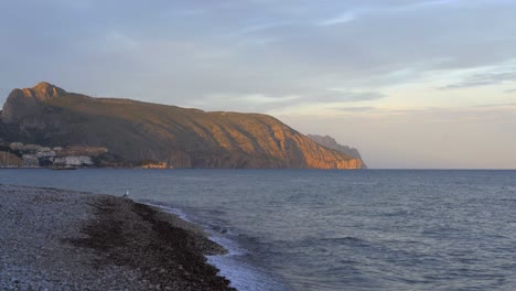 Rocky-cliff-near-rippling-sea
