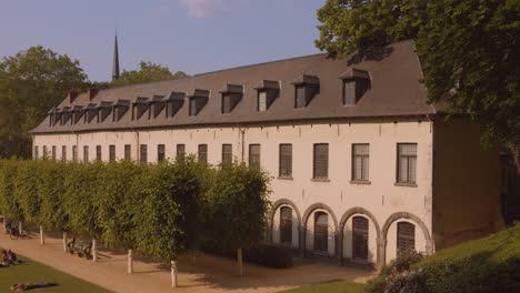 Pan-shot-of-the-late-afternoon-construction-of-La-Cambre-Abbey-Historic-landmark-religion-in-Brussels,-Belgium