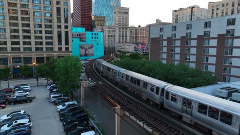 Aerial-tracking-shot-of-L-train-on-elevated-train-tracks-in-downtown-Chicago,-Illinois