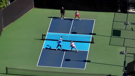 Pickleball-foursome-volley-for-a-point---aerial-overhead-view