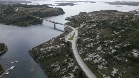 Cars-Driving-on-Road-in-Øygarden,-Norway-near-Bergen-with-Beautiful-Landscape-and-Cars-driving-over-Svelgen-Bridge