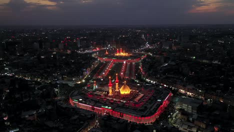 Eine-Von-Einer-Drohne-Aufgenommene-Nachtaufnahme-Schiitischer-Besucher-Und-Pilger-In-Der-Moschee-Und-Dem-Schrein-Von-Imam-Hussein-Und-Abbas-In-Karbala,-Irak