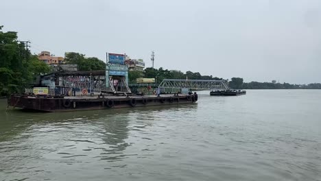Kolkata,-India:-Toma-En-Primera-Persona-Desde-Un-Ferry-Mientras-Atracaba-En-Un-Puerto-Fluvial-A-Lo-Largo-De-Las-Orillas-Del-Río-Ganges-En-Un-Día-Nublado
