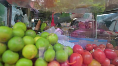 Street-vendor-sorting-through-the-orders-of-Somtam-Thai-papaya-salad,-written-by-her-customers-at-a-roadside-restaurant-in-the-streets-of-Bangkok,-Thailand