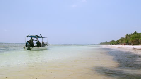 Scuba-Divers-Riding-A-Boat-Near-Tropical-Coastline-Of-Indian-Ocean-In-Diani-Beach,-Kenya,-Africa