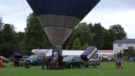 Hand-held-shot-of-a-hot-air-balloon-pilot-getting-his-aircraft-ready-for-take-off