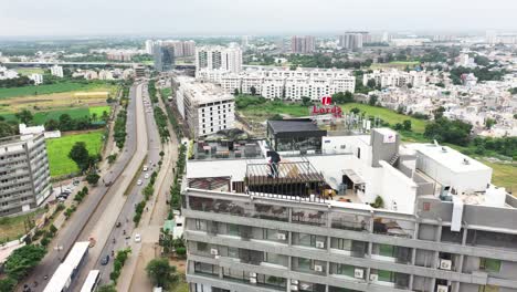 Cámara-Aérea-De-Drones-Que-Avanza-Mostrando-El-último-Piso-Del-Edificio-Iris-Y-Una-Carretera-Vehicular-Justo-Al-Lado-Del-Edificio