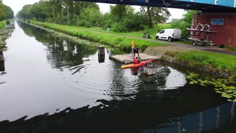 Kayak-instructor-helping-kayakker-out-of-the-canal