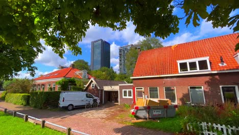 Modern-flat-buildings-behind-traditional-dutch-farm-houses-in-Amsterdam-Noord