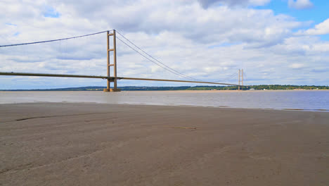 Aerial-drone-footage-reveals-Humber-Bridge,-the-12th-largest-single-span-suspension,-spanning-the-River-Humber,-linking-Lincolnshire-to-Humberside-amid-traffic