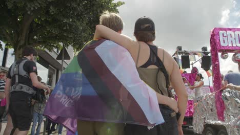 Lesbian-couple-walking-arm-in-arm-during-the-Antwerp-Pride-Parade-2023-in-Belgium