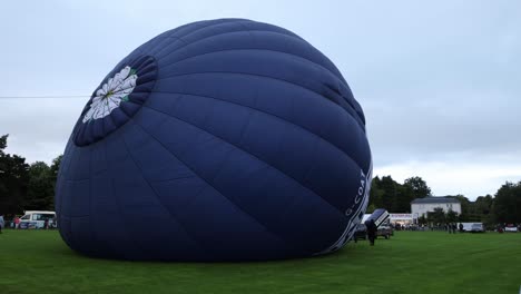 Hand-held-shot-of-a-hot-air-balloon-filling-up-at-Strathaven-Balloon-Festival