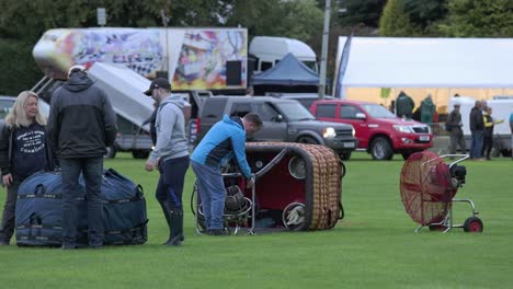 Hand-held-shot-of-a-crew-setting-up-the-different-parts-at-the-Strathaven-Balloon-festival