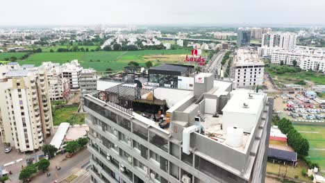 An-aerial-drone-camera-is-circling-a-terrace-garden-restaurant-on-the-top-floor-of-the-high-rise-Building