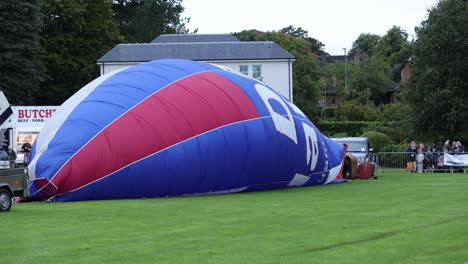 Hand-held-shot-of-a-hot-air-balloon-filling-up-with-air-at-Strathaven-Balloon-Festival