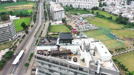 Aerial-view-of-Skyscraper-Building-of-Rajkot-City,-Terrace-restaurant-built-on-the-top-four-of-highrise-building-is-looking-very-beautiful,-Amazing-Aerial-View-of-Rajkot-City