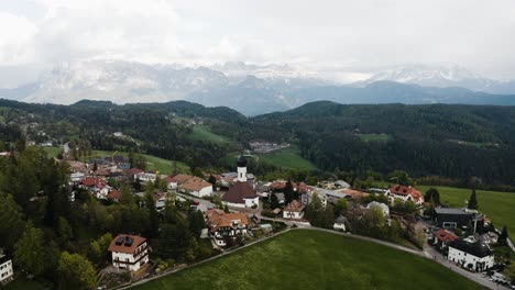 Aerial-view-of-Oberbozen,-Italy-out-in-the-countryside