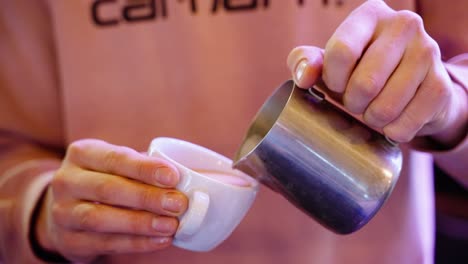 Hand-Of-Barista-Preparing-Cappuccino-Coffee-Pouring-Milk-Making-Latte-Art