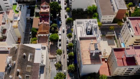 Drone-shot-flying-over-the-roofs-and-streets-and-following-the-cars-on-the-street