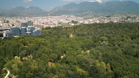 Cinematic-Establishing-Shot-of-Grand-Park-of-Tirana---City-and-Mountains-in-Background