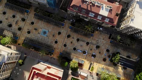 Drone-top-shot-lifting-from-a-the-townsquare-in-Marbella,-Spain