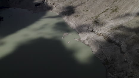 Wide-angle-shot-of-mountain-glacier-lake-in-Eastern-Alps,-Austria,-Drone-shot
