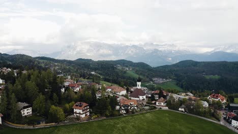 Aerial-view-soaring-over-Soprabolzano-in-Italy's-mountainous-countryside