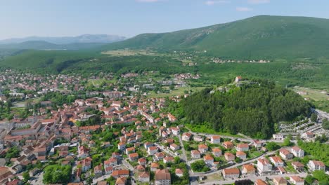 Aerial-flight-over-beautiful-green-town-Sinj-in-Croatia-on-a-sunny-summer-day