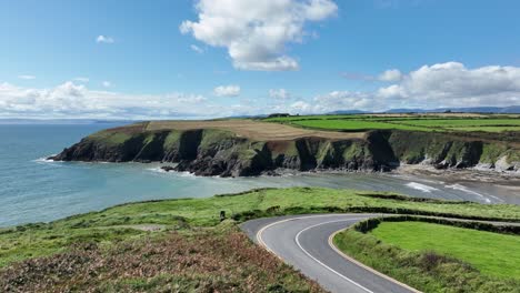 Drone-Coast-of-Ireland-flying-over-the-coast-road-to-Kilmurrin-Cove-Copper-Coast-Waterford-on-a-summer-day