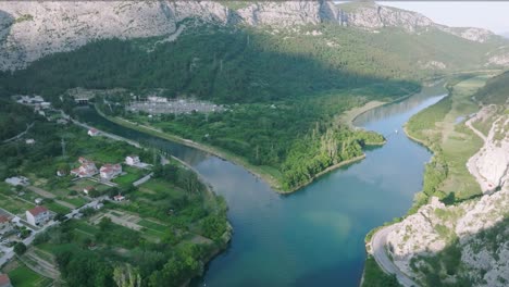 Aerial-view-of-Cetina-River-Canyon-near-Omis,-Sunlight-falling-on-the-mountains-and-trees