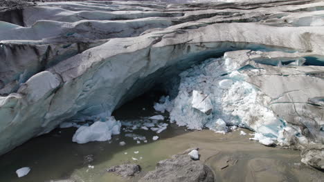 Pasterze-glacier-melting-ice-cave-due-to-climate-change,-Retreating-glacier-of-Austrian-Alps,-Austria,-Aerial-Closeup