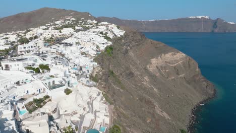 Observe-a-couple's-romantic-escapade,-unveiling-the-allure-of-Santorini-from-an-aerial-view