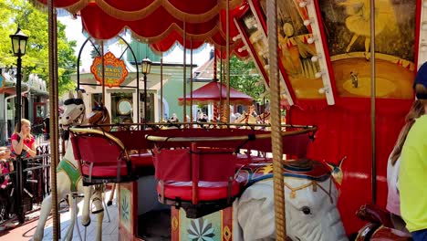 People-having-fun-riding-classic-carousel-in-Grona-Lund-Tivoli-in-Stockholm-Sweden