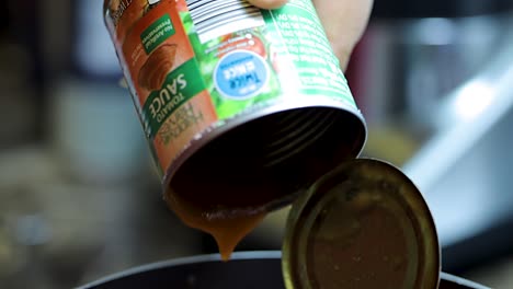 close-up-shot-of-delicious-tomato-sauce-being-poured-into-a-pot-for-a-home-made-pizza