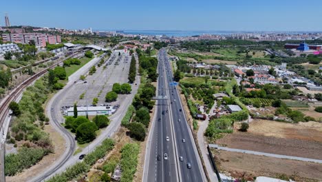 Drone-shot-flying-over-and-following-the-highway-in-Almada,-Portugal