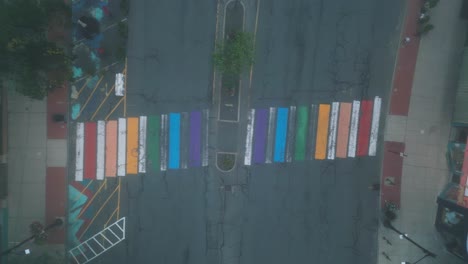 Aerial-ascend-rising-above-rainbow-colored-cross-walk-in-northampton-massachusetts-on-foggy-early-cold-dewy-morning