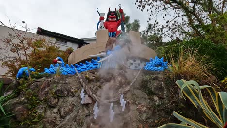Red-demon-statue-at-Kamado-Jigoku-hot-spring-in-Beppu,-Oita