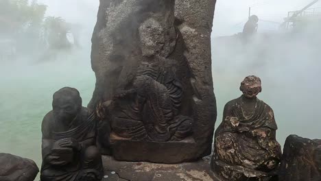 Old-eroded-statues-in-front-of-a-geothermal-hot-spring-in-Japan