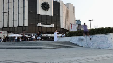 Tourists-walking-by-the-entrance-to-National-Palace-of-Culture,-Bulgaria,-Congress-Centre-Sofia-NDK