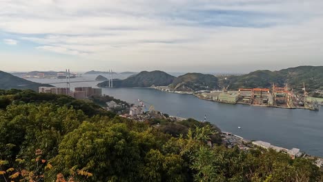 Vie-over-the-hills-bay-and-port-of-Nagasaki,-revealing-it's-sykline