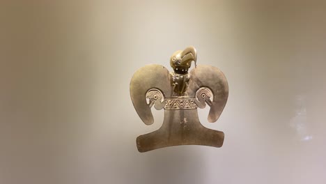 Pre-Columbian-indigenous-amulet-object-of-pure-gold-exhibited-in-showcase-in-Bogota