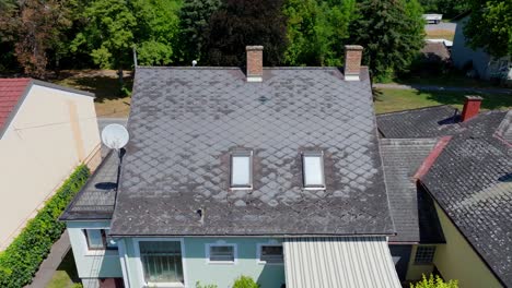 Fly-Away-At-Old-Roof-Made-Of-Eternit-Gray-Tile-In-A-Residential-Building