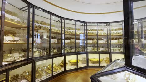 Imperial-Palace-With-Century-Old-Bronze-Gilt-Tableware-Inside-The-Display-Cabinet-In-Sisi-Museum,-Vienna,-Austria