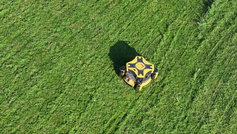 Drone-Shot-of-Modern-Robotic-Lawn-Mower-Moving-on-Green-Meadow-on-Sunny-Day
