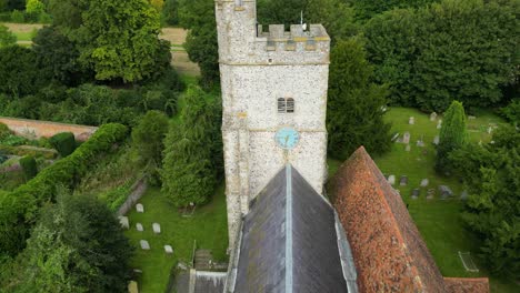 A-drone-shot-of-Holy-Cross-church-in-Goodnestone,-pushing-in-towards-the-church-tower