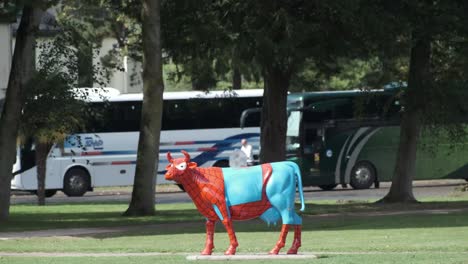 Camp-site-in-mont-Saint-Michel-in-Normandy,-France-is-decorated-with-sculptures-of-cows-in-different-colourful-outfits