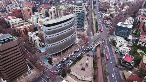 Bird's-eye-view-of-a-terrace-with-a-group-of-people-gathered-and-in-the-financial-center-of-Santiago-Chile-with-high-vehicular-traffic