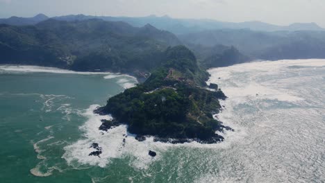 Aerial-view-over-Menganti-beach-and-headland-in-Central-Java,-Indonesia